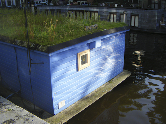 houseboat with canal reflection
